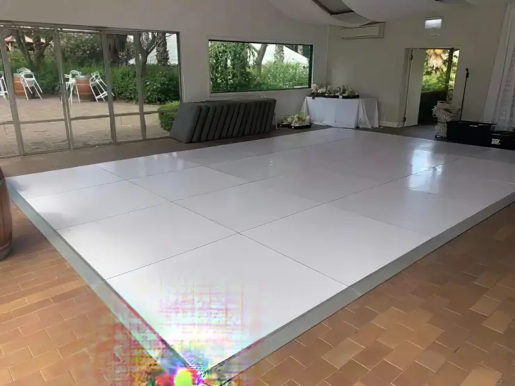 White gloss dance floor set up for an indoor wedding reception